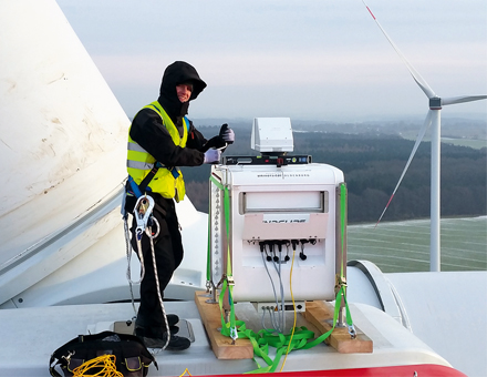 Ein ForWind-Wissenschaftler installiert das laseroptische Lidar-Messgerät zur Erfassung der Nachlaufströmung auf der Gondel einer Windenergieanlage der Firma eno energy.